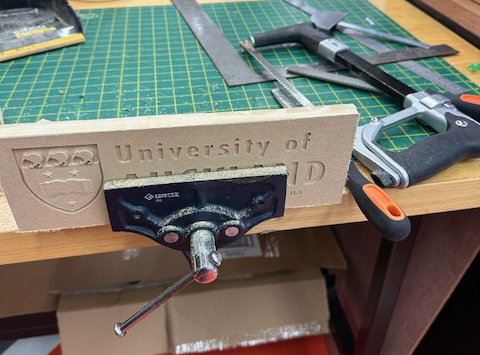 Carved logo on vice ready to be finished and painted